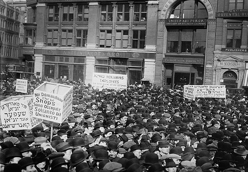 [source Wikipedia] May Day 1913, strikers and protesters rally in Union Square, with signs in Yiddish, Italian and English