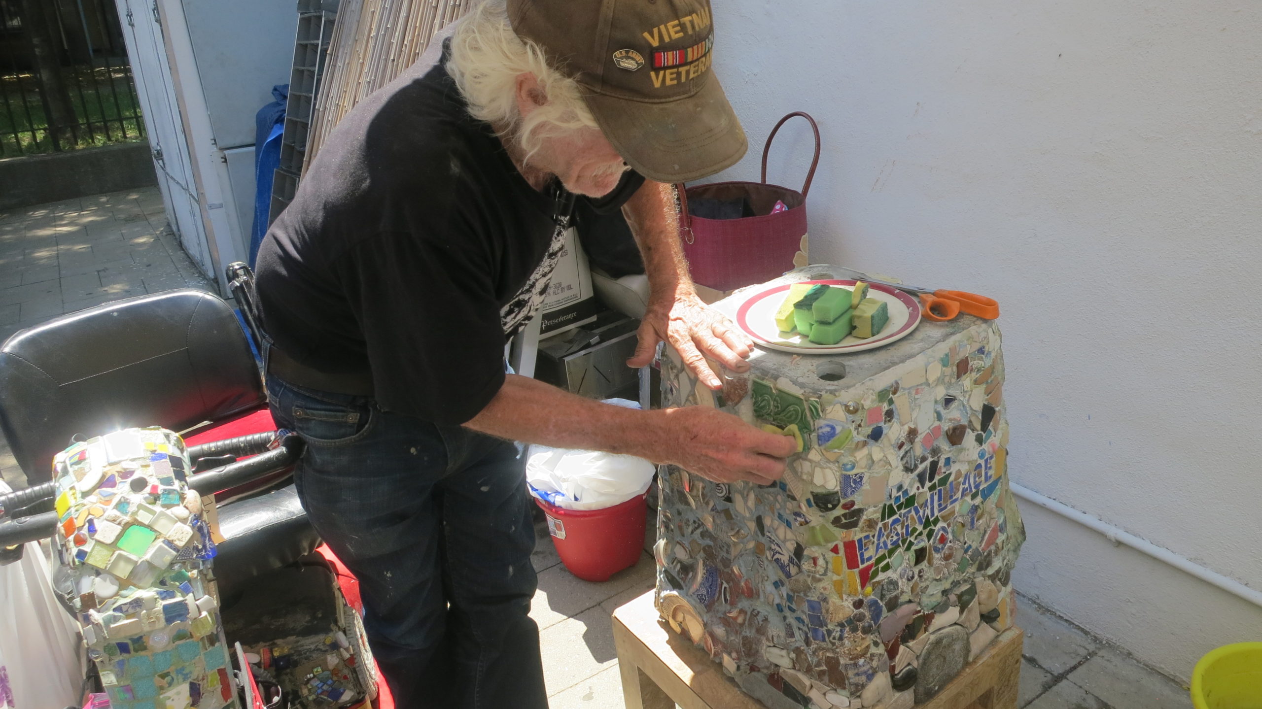 Jim Power, Mosaic Man, performing some of the delicate work. Photo by Julie Powell
