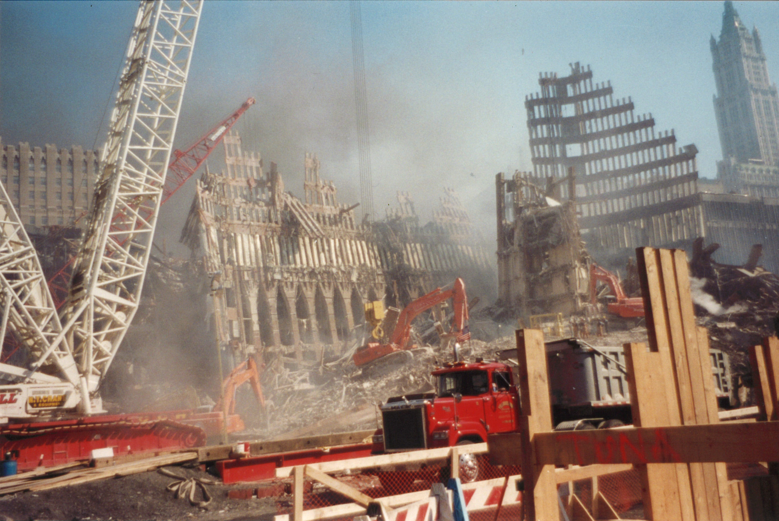 Trucks and Cranes Working Amongst the Rubble and Destroyed