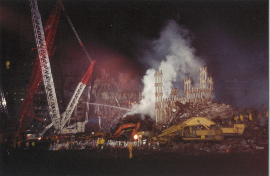 Cranes and Diggers beside Smoke Rising through destroyed Exoskeleton ...
