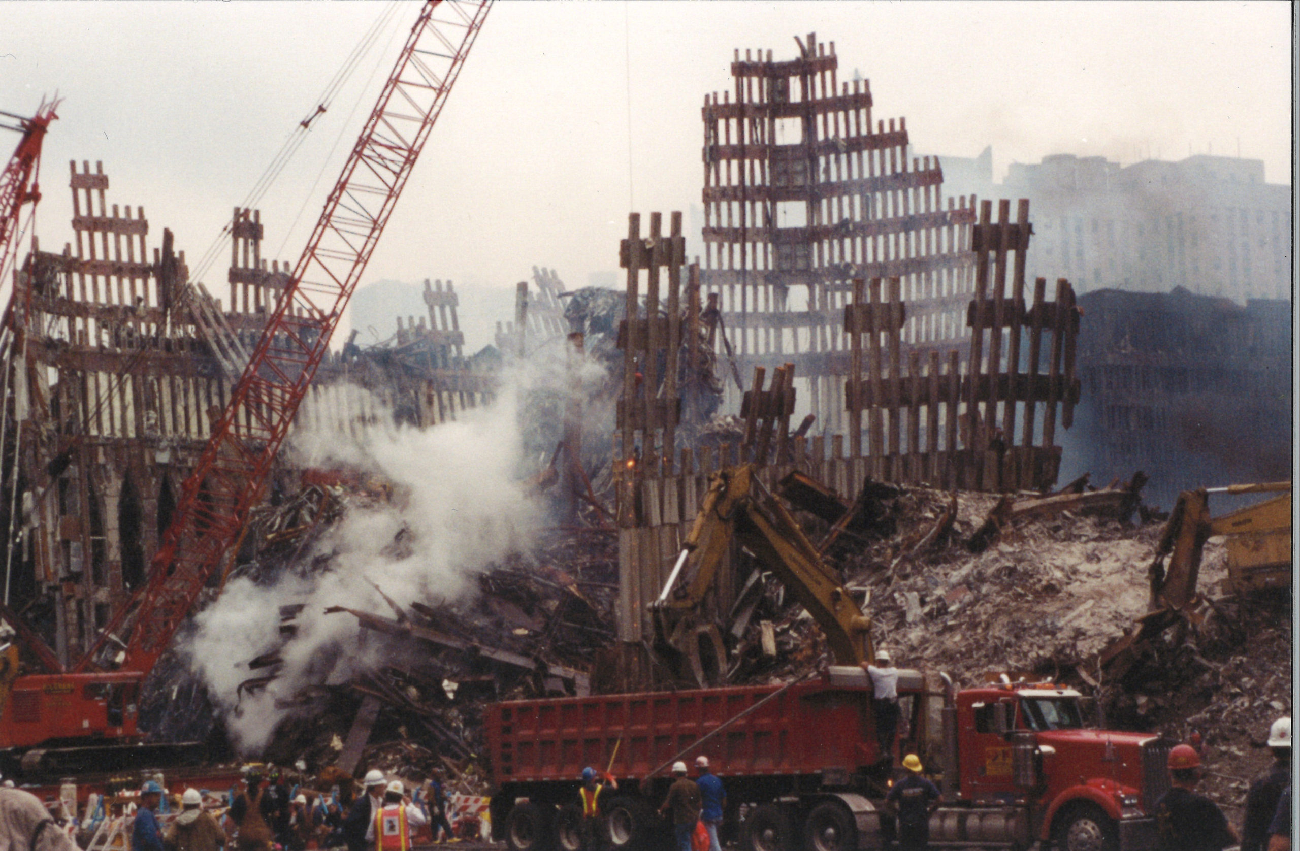 Diggers, Cranes, and Men working in Smoke with Falling Exoskeleton ...