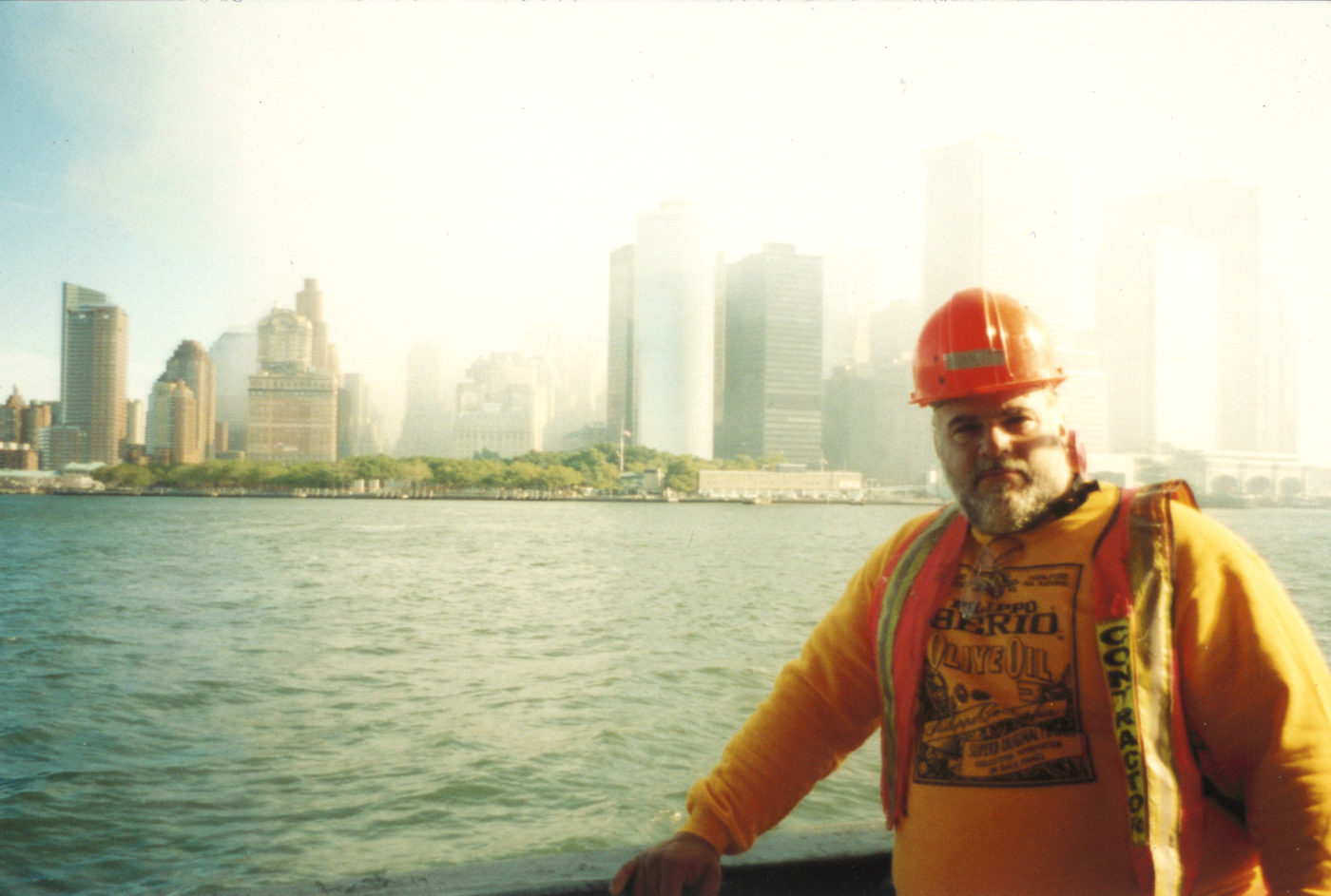 Photo of unknown worker from the water with the Battery and smoke-filled downtown skyline behind.