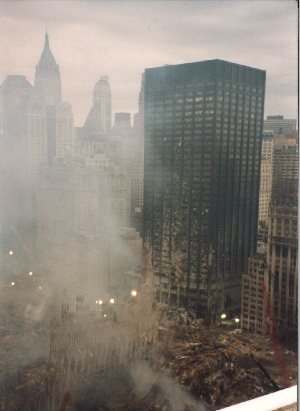 Smoke rising through the WTC Exoskeleton wirh blown out windows on the Deutsche Bank building