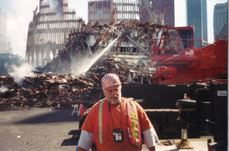 Worker Standing infront of A Hose Spraying Down Debris at Ground Zero