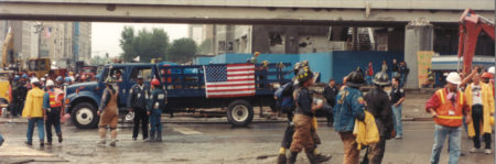 Workers and Fire Fighters Busy by a Passanger Overpass