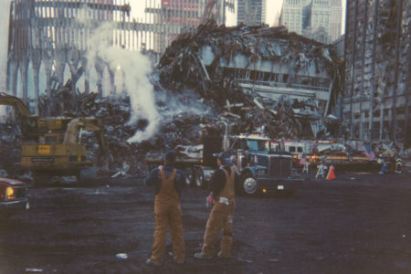 Workers at Ground Zero looking east with Ladder 87 in background