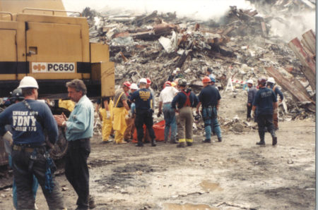 Workers, Police and Fireman Assesing the Debris