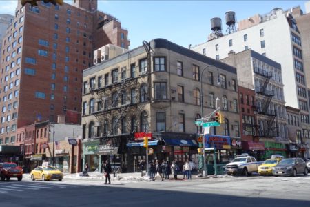 Brown four-story buildings: 523-27 Sixth Avenue is at the corner; 519 is to the left; 102 and 104-106 West 14th Street are the two buildings to the right