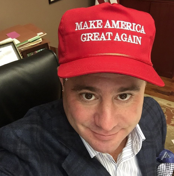 Man wearing Make America Great Again red cap