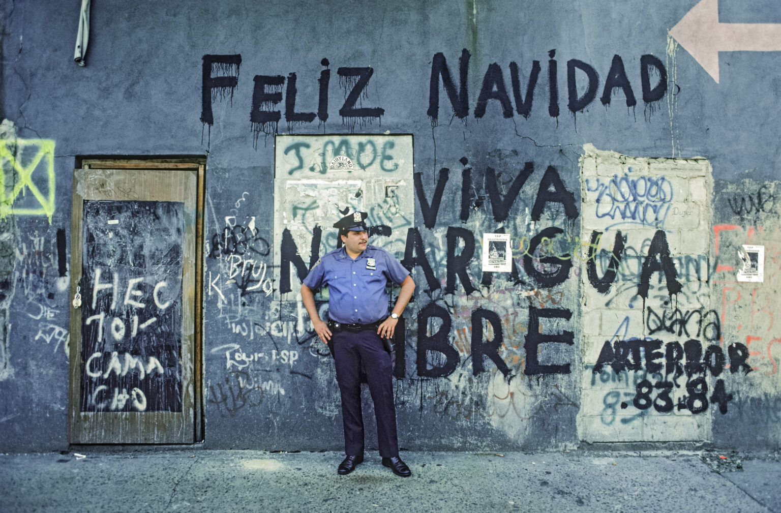 Police officer Samuel Bomil, in front of graffitied storefront on ...